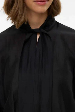 Blusa feminina de manga comprida com laço no gola