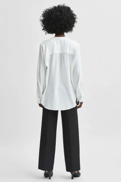Blusa fluida com decote em bico confecionada com materiais reciclados.
