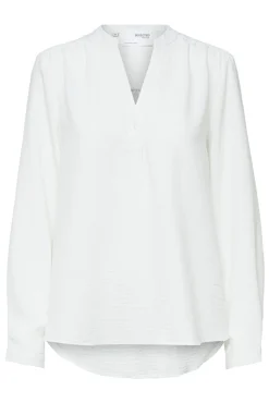 Blusa fluida com decote em bico confecionada com materiais reciclados.